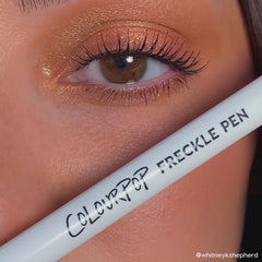 model showing how to apply the Soft Brown ColourPop Freckle Pen felt-tip applicator to dot natural-looking freckles