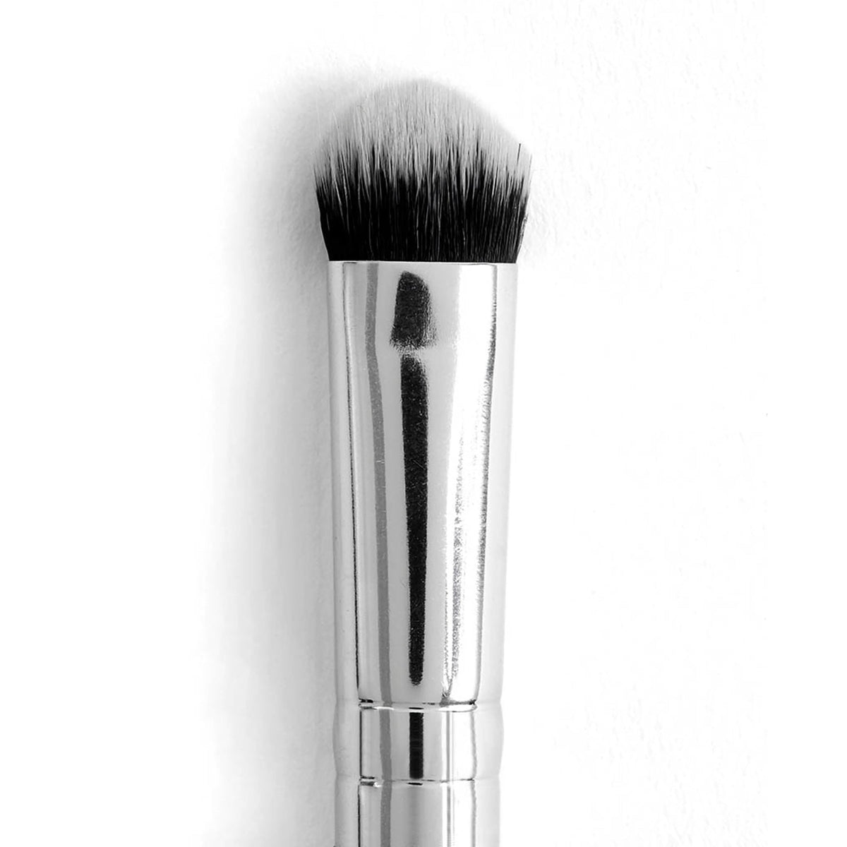 ColourPop Medium Dome Brush showcasing dense, domed synthetic bristles with a black-to-white gradient and a shiny silver ferrule, positioned upright on a white background; a versatile makeup brush for precise blending and smudging.