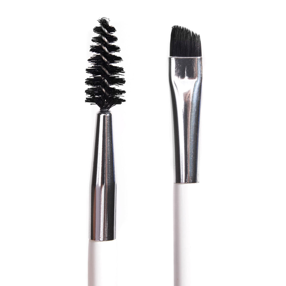ColourPop Brow Dual Ended Brush makeup brush shaping and defining eyebrows, featuring a black spoolie on one end and an angled flat brush on the other with silver ferrules and a white handle, shown in a studio close-up on a white background.