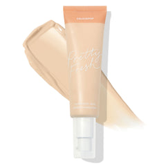 ColourPop Pretty Fresh Tinted Moisturizer tube in Fair 1 N stands with a white pump and peach cap over a creamy beige swatch, showcasing the neutral fair shade and hyaluronic acid formula for light, dewy coverage.