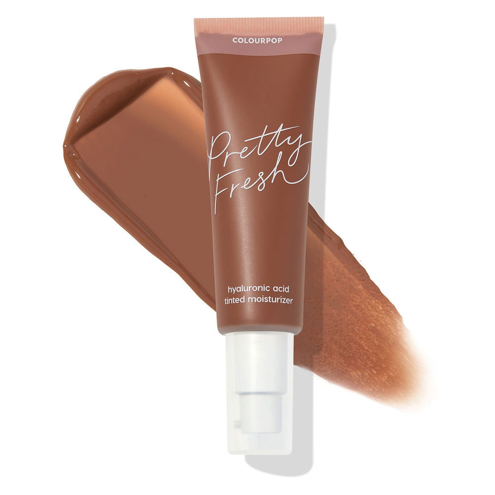 ColourPop Pretty Fresh Tinted Moisturizer, shade Deep Dark 21 W, shown in a mauve-capped pump tube labeled Pretty Fresh, angled over a rich deep-warm brown swatch; hyaluronic acid formula for dewy, sheer coverage on a white background.