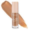 ColourPop Pretty Fresh Creamy Concealer in Dark 158 W stands upright with a blush-beige cap and clear tube marked “Pretty Fresh” and “hyaluronic,” while a warm tan shade swatch streaks behind on a white background.