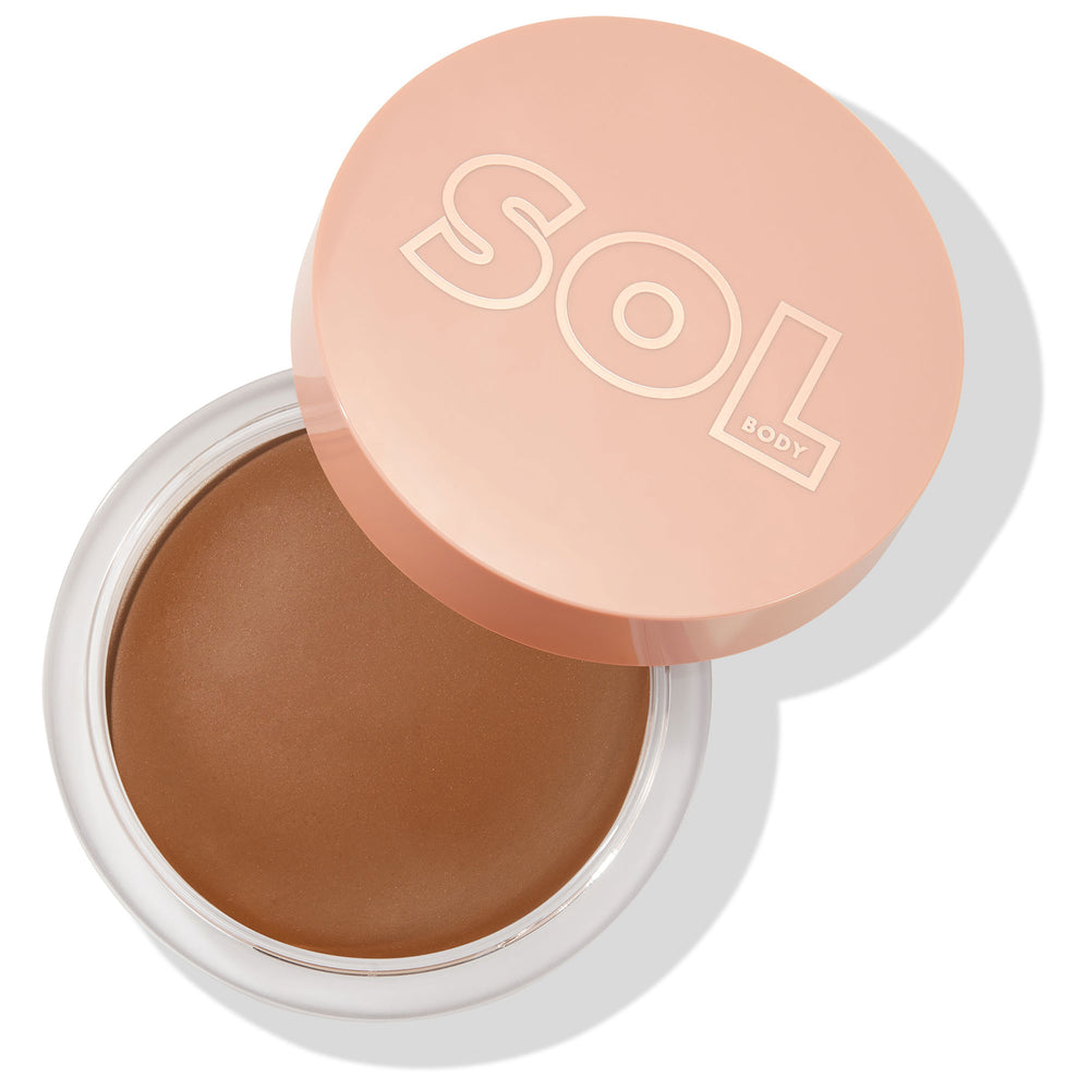 Open jar showcases the Dark shade of ColourPop SOL Face & Body Bronzing Balm, a creamy deep-brown bronzer, with a peach lid embossed “SOL BODY” slightly offset atop a clear round pot, casting a soft shadow on a white background.