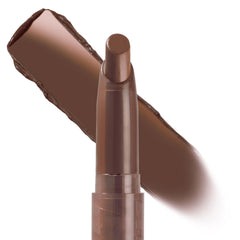 ColourPop Lippie Stix In the Nude stands upright with its bullet tip exposed, showing a creamy deep brown nude shade as a matching swatch streaks behind the tube on a white background, highlighting the slim twist-up design.