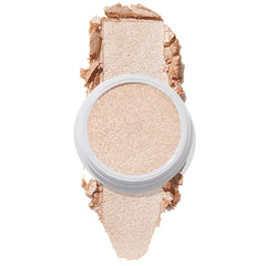 ColourPop Super Shock Highlighter Flexitarian swatched in a reflective icy champagne tone, the creamy formula pressed in a white pot with a bold swipe above and below on a white background, showing high-impact shimmer.