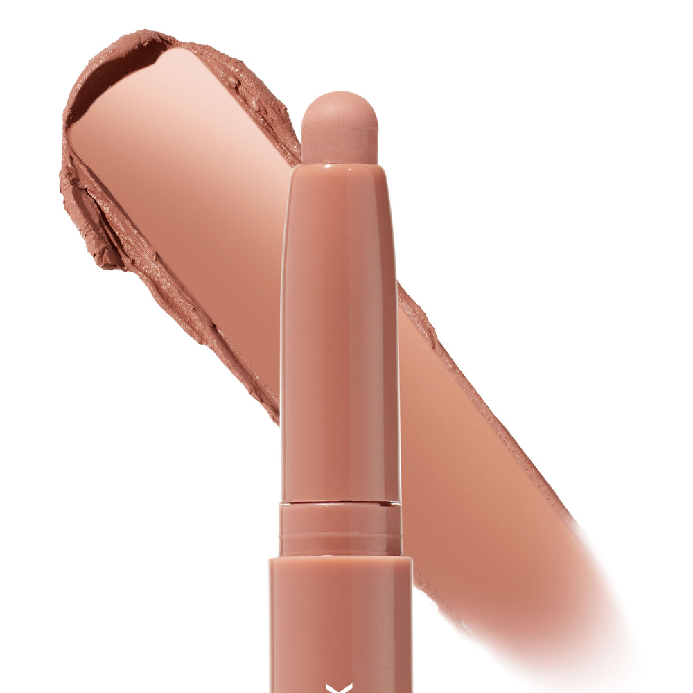 ColourPop Shadow Stix Bare With Me glides a rosy nude cream eyeshadow swatch behind a twist-up stick, highlighting the rounded tip and smooth payoff on a white background.