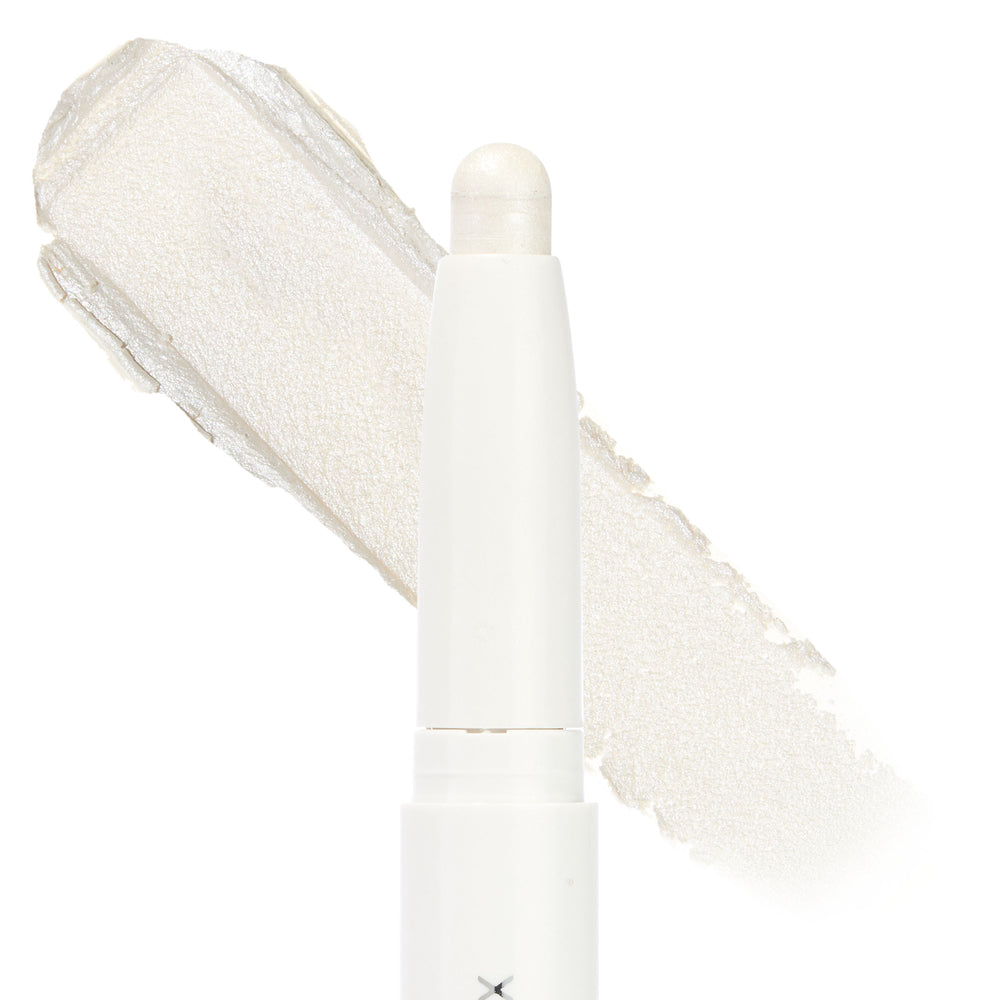 Cold Girl ColourPop Shadow Stix standing upright with its twist-up bullet exposed, showing an icy pearl white shimmer; a broad swatch of the creamy eyeshadow sits behind on a clean white background.