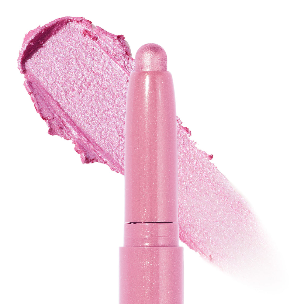 ColourPop Shadow Stix Juicy Gossip shows its rounded bullet tip with a wide swipe of creamy, shimmery cool pink behind it, highlighting the metallic finish and twist-up crayon design on a clean white background.