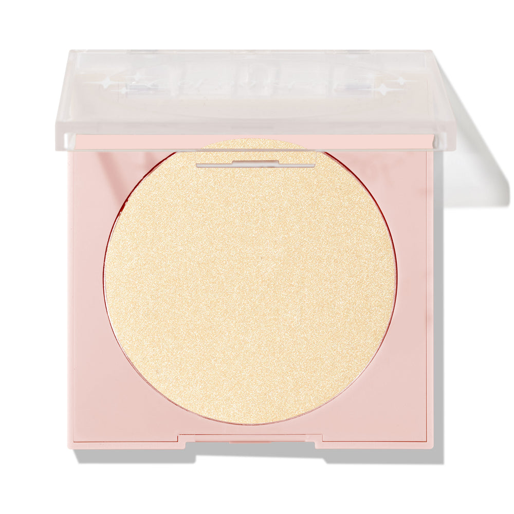 Minted pressed powder highlighter sitting half-open, displaying a large circular pan of pale gold shimmer in a blush-pink compact with a clear lid; ColourPop Pressed Powder Highlighter shade Minted for a luminous glow.