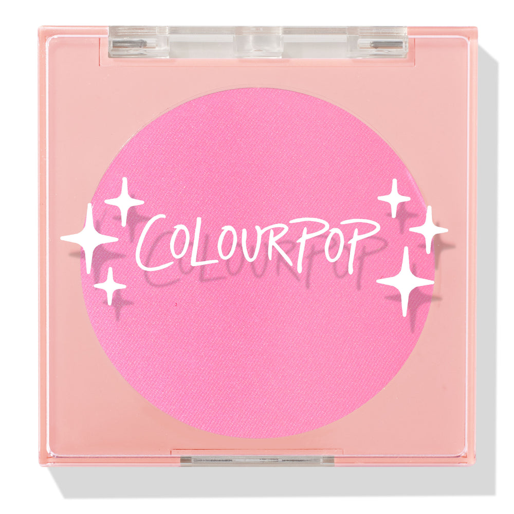 Prairie Air ColourPop Pressed Powder Blush compact sits closed, displaying a vibrant bubblegum pink pan beneath a clear lid with white sparkle icons and the ColourPop logo, housed in a peach square case on a white background.