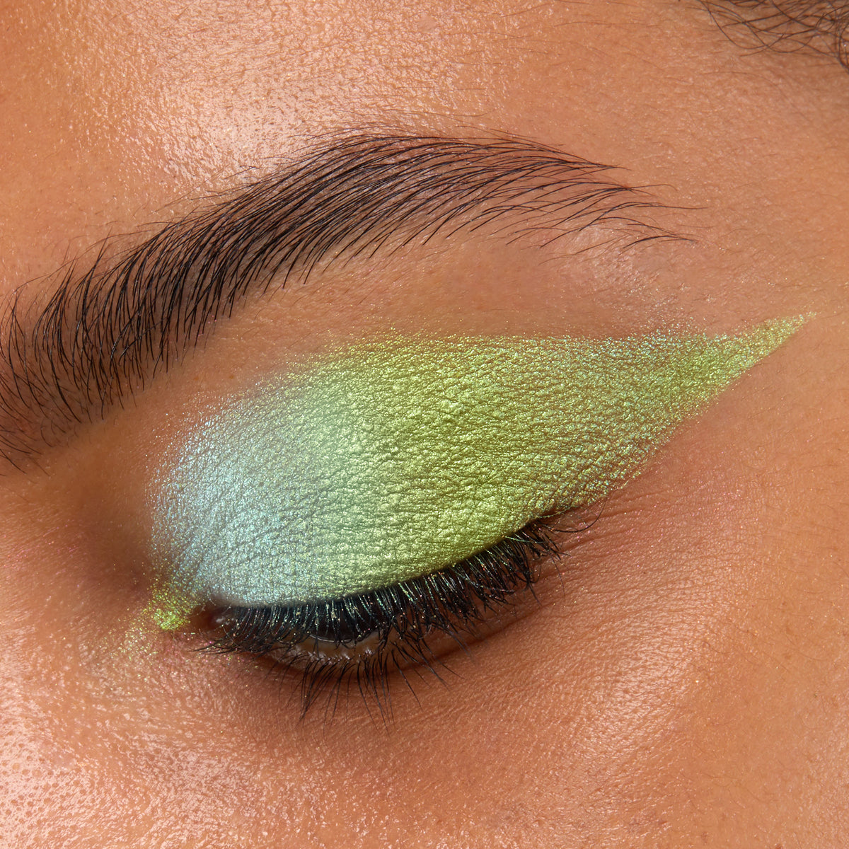 Closed eye showcases See U Later Chrome Liquid Shadow, a ColourPop Chrome Liquid Shadow, blended from icy mint to lime green with a metallic shift and sharp winged edge, highlighting lashes and brow area in a tight close-up.